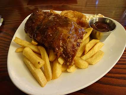 Bristol half rack with chips, onion rings, and slaw