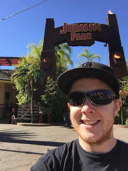 Michael in front of the Jurassic Park ride